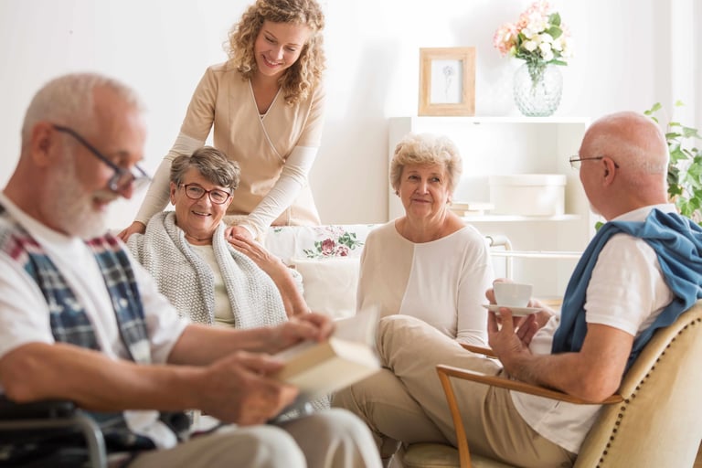 Group of senior friends sitting together at senior community living room