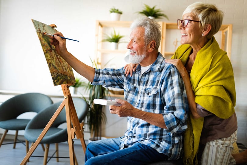 Man and woman are enjoying spending time together painting a picture
