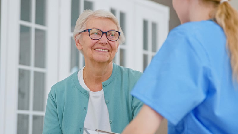 Senior lady nods her head listening to caregiver recommendations