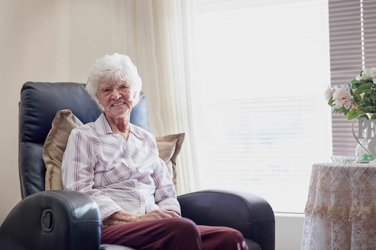 Portrait of a happy senior woman relaxing on a chair at home