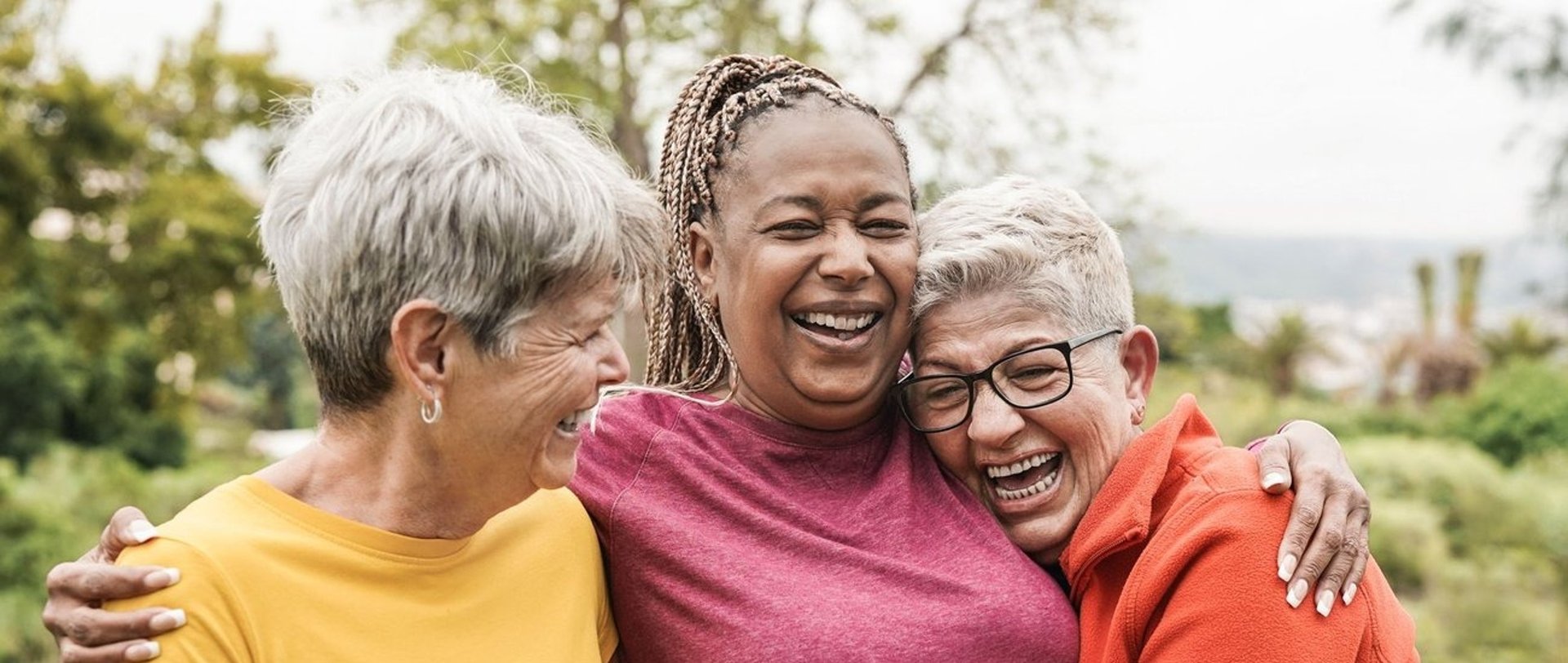 senior friends embracing