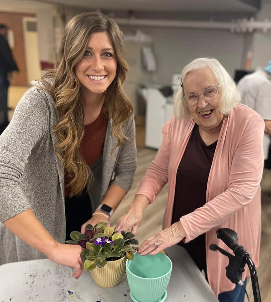 A caregiver helping a resident with gardening