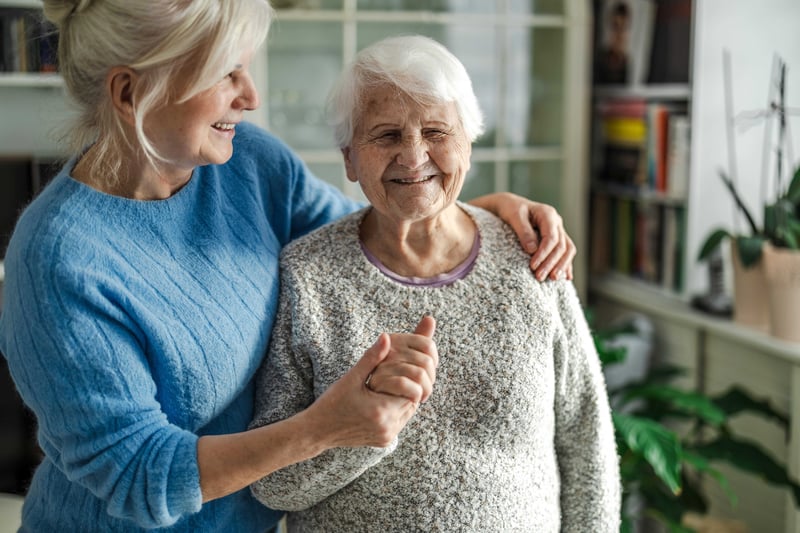 Older adult and caregiver together at home