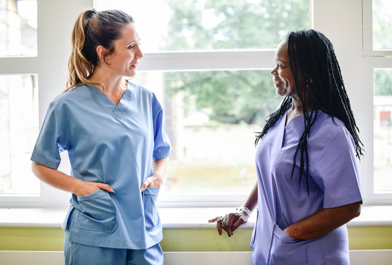 Nurses having a conversation in the hospital hallway