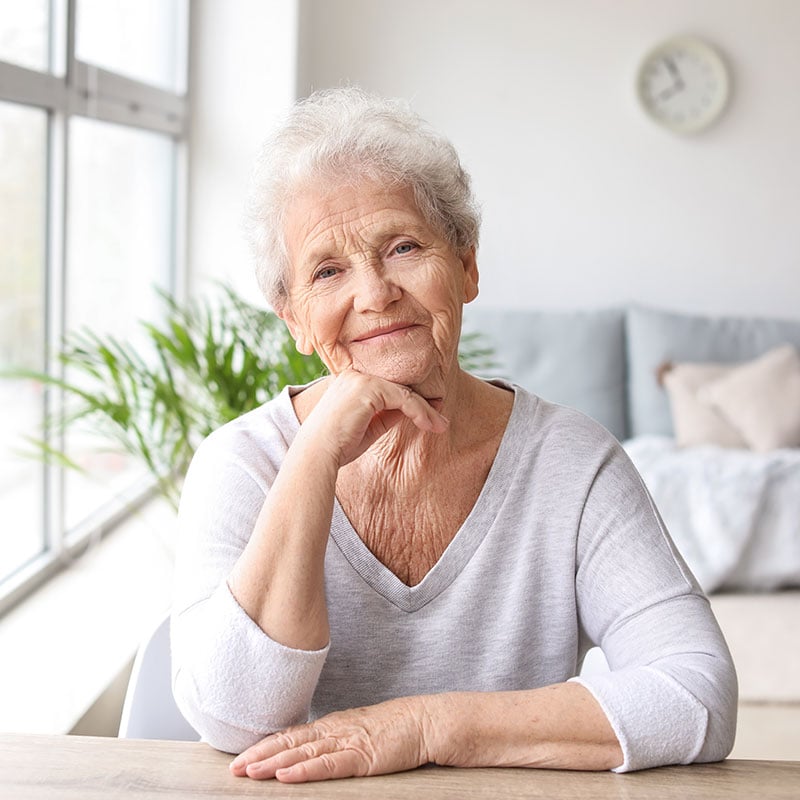 An older woman smiling at the camera