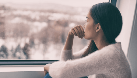 woman looking out window