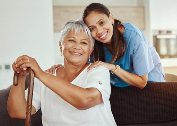 An older woman and younger woman smiling at the camera