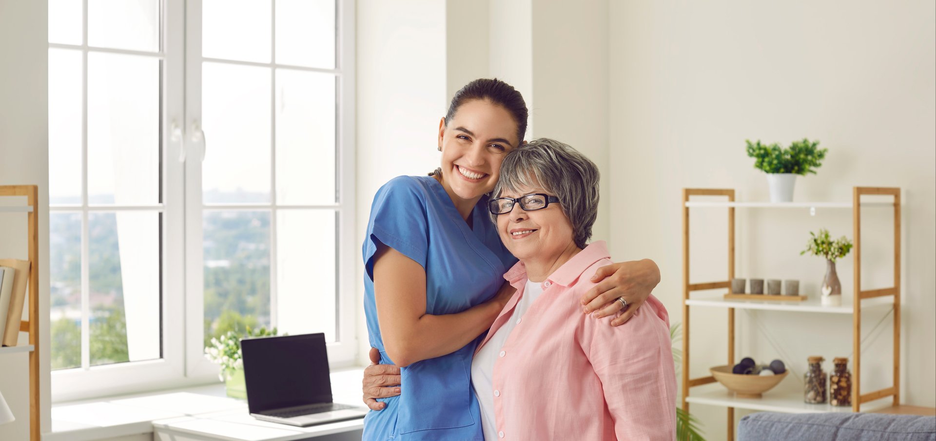caregiver and senior woman embracing