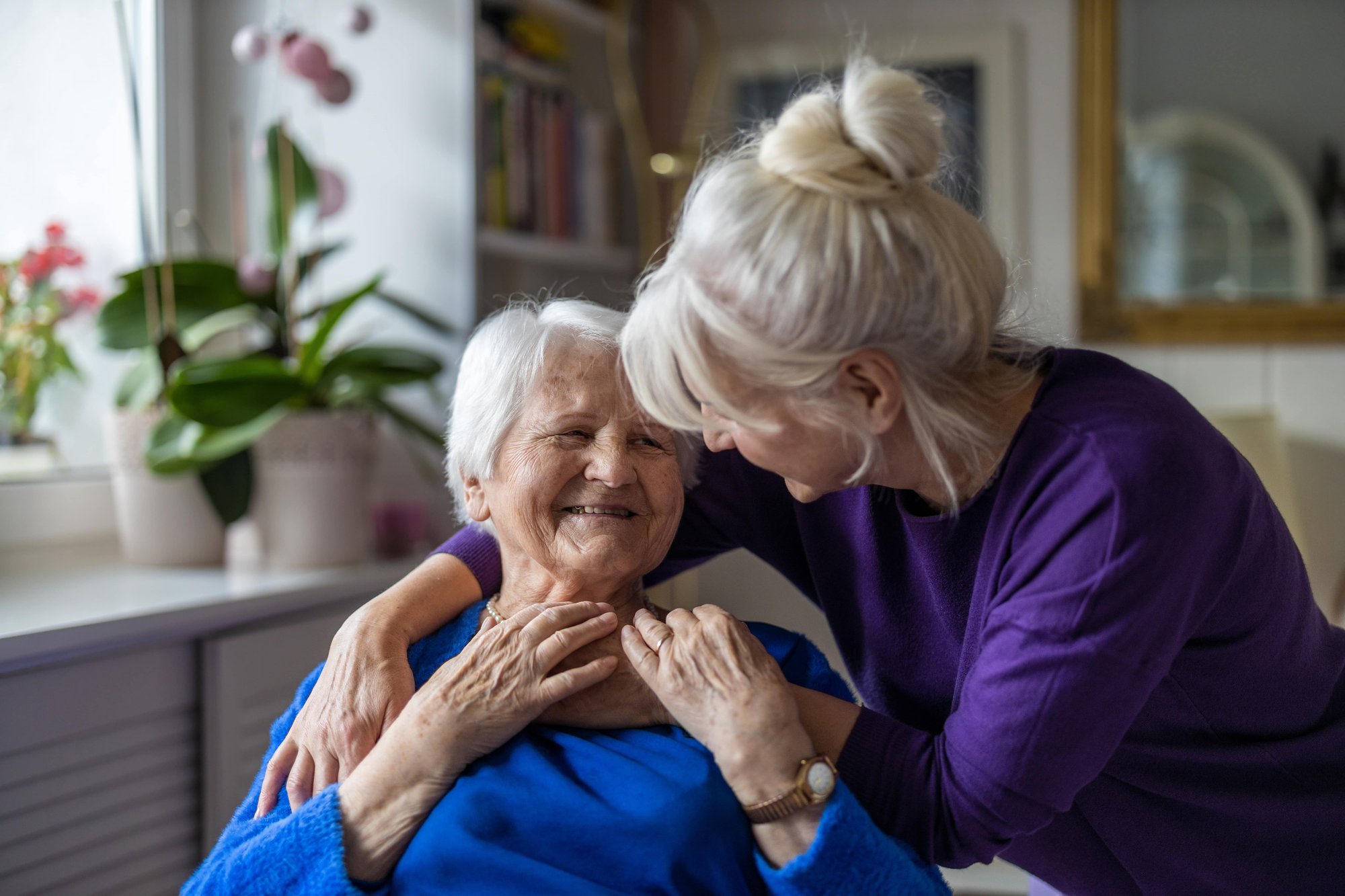 Woman hugging her elderly mother Woman hugging her elderly mother