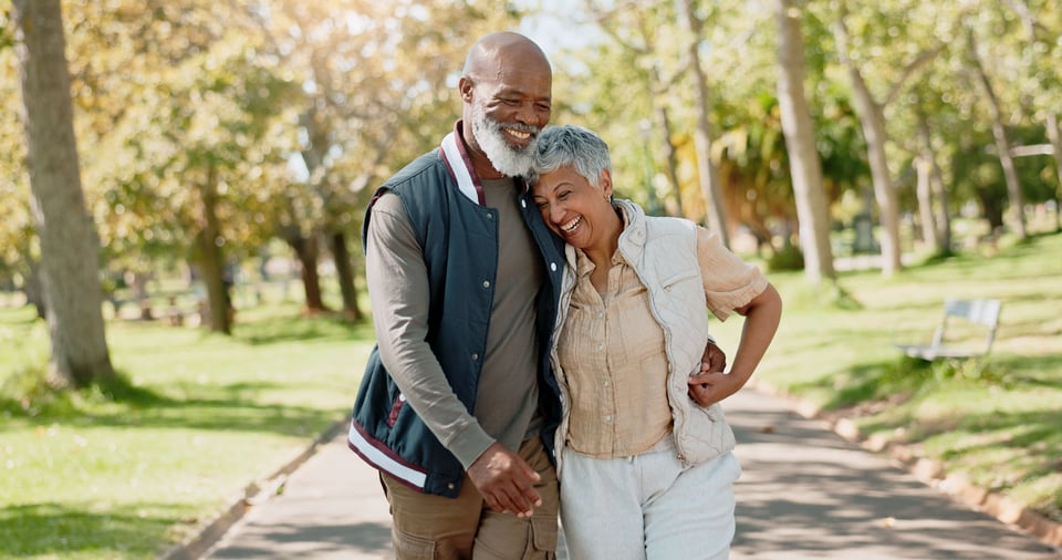 Happy senior couple in park getting exercise  in retirement in nature