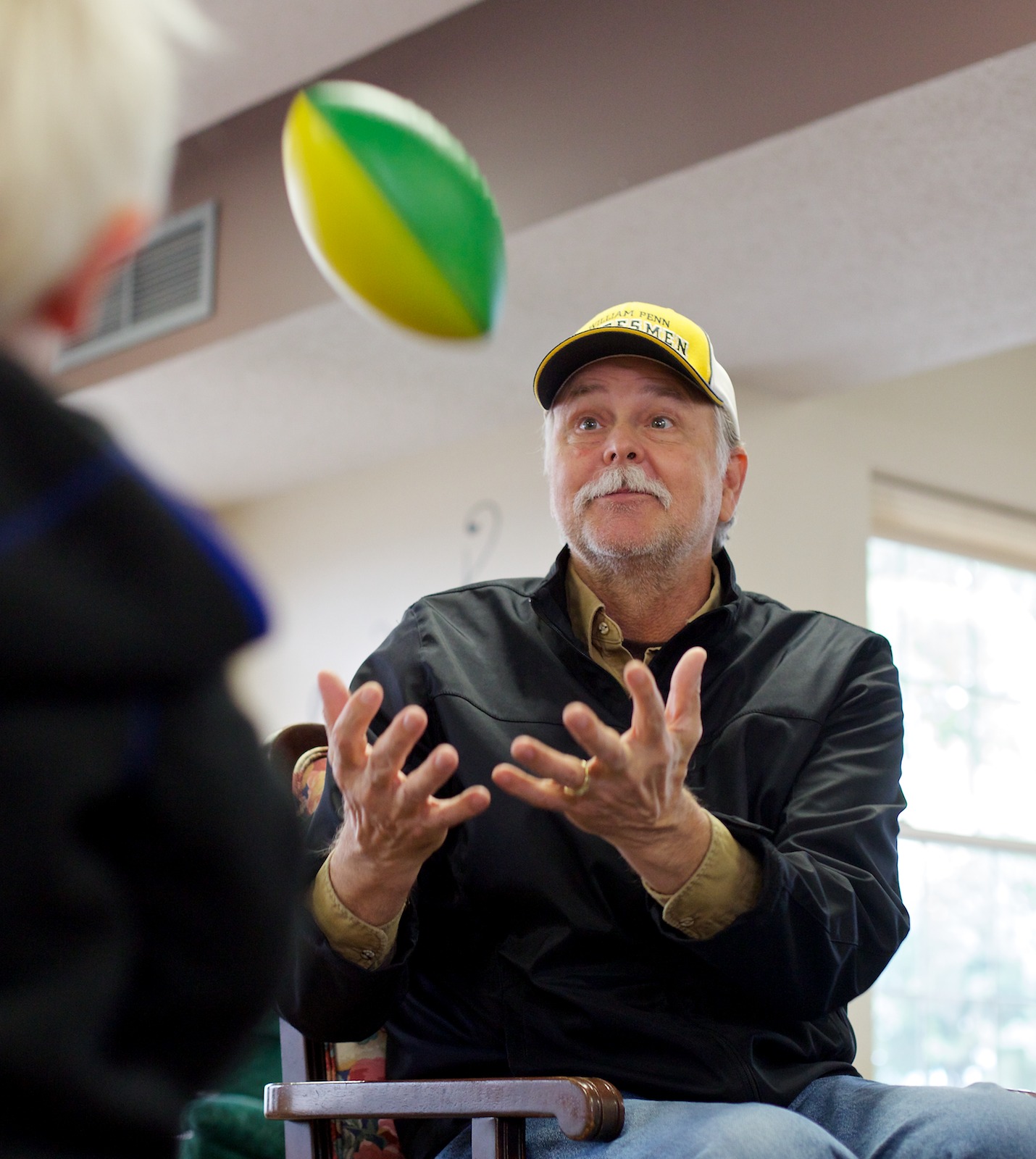 Adult day participant playing catch