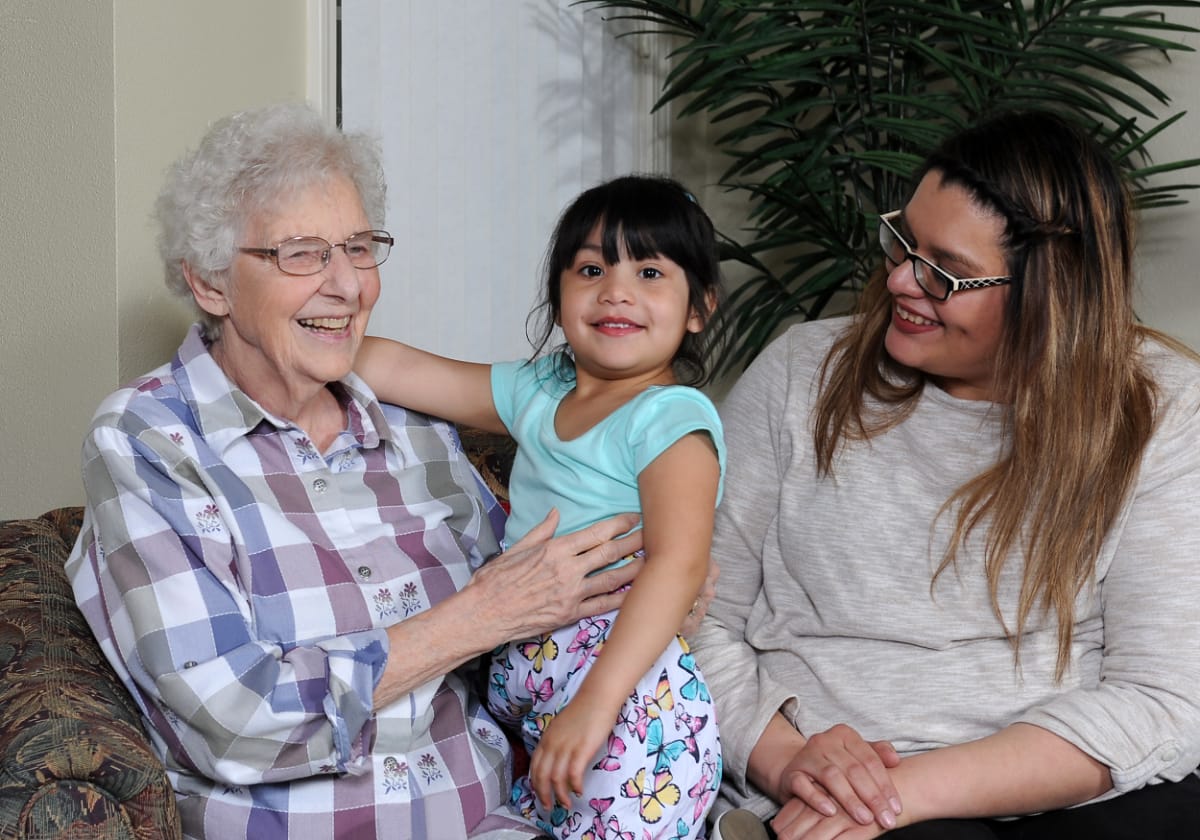 A resident visiting with her family