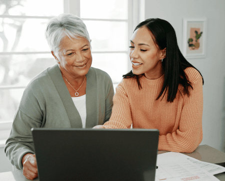 Mother and daughter reviewing costs on laptop 