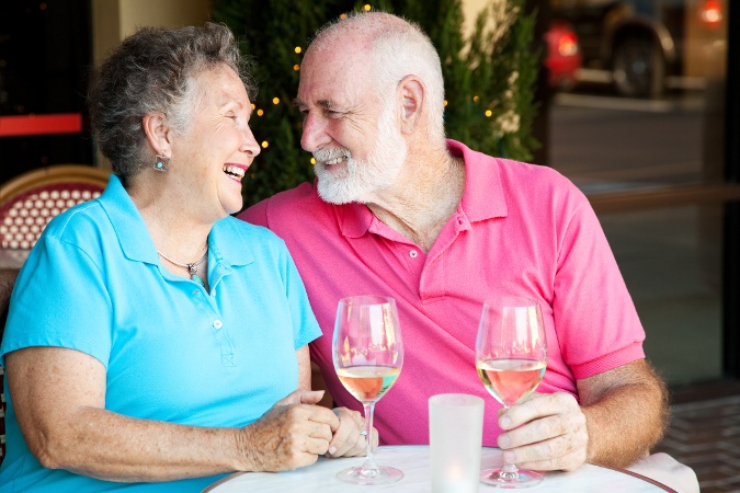 Couple smiling while drinking wine
