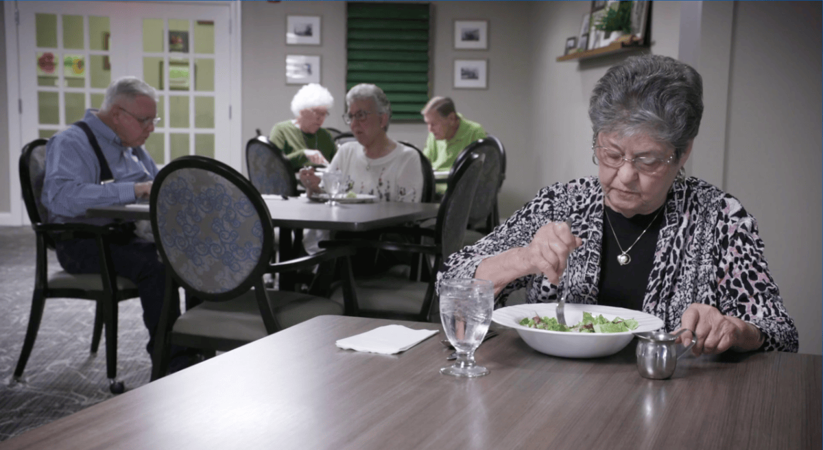 Older adults eating in the cafeteria