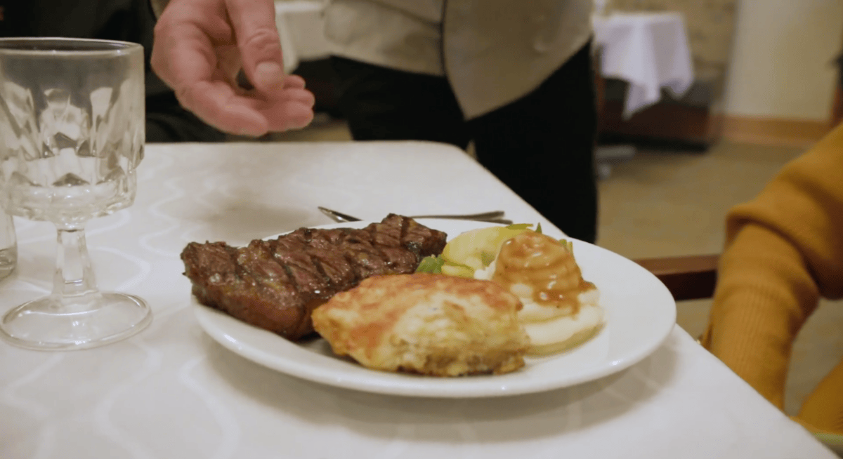 Closeup of a steak, mashed potatoes, and a biscuit 