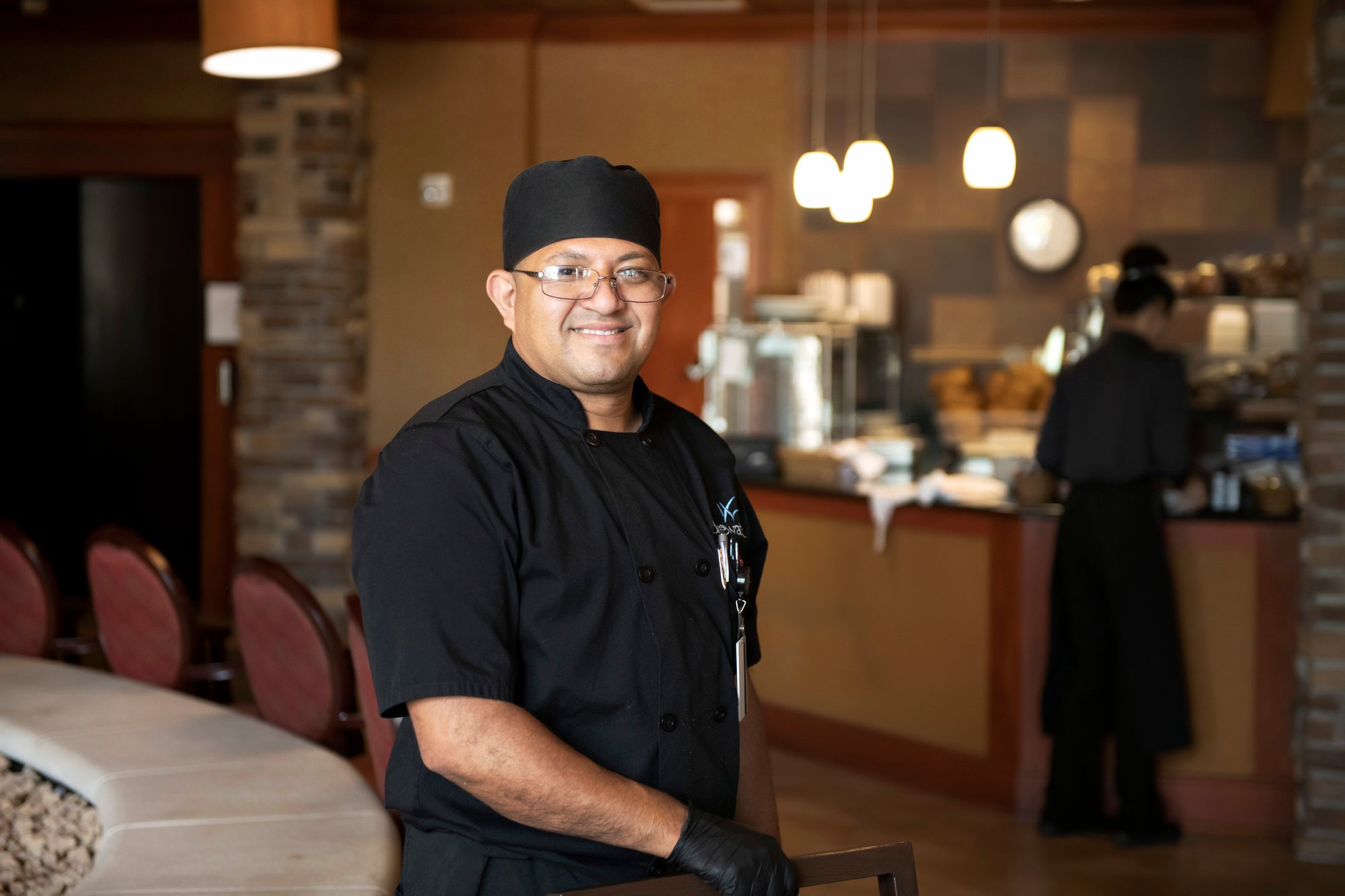 A chef smiling at the camera.