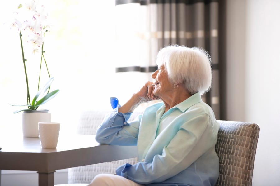 senior resident smiling with coffee