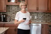 woman drinking wine in her kitchen