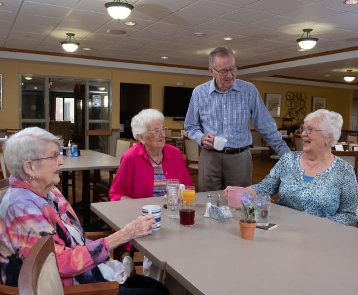 Senior friends talking in a cafeteria