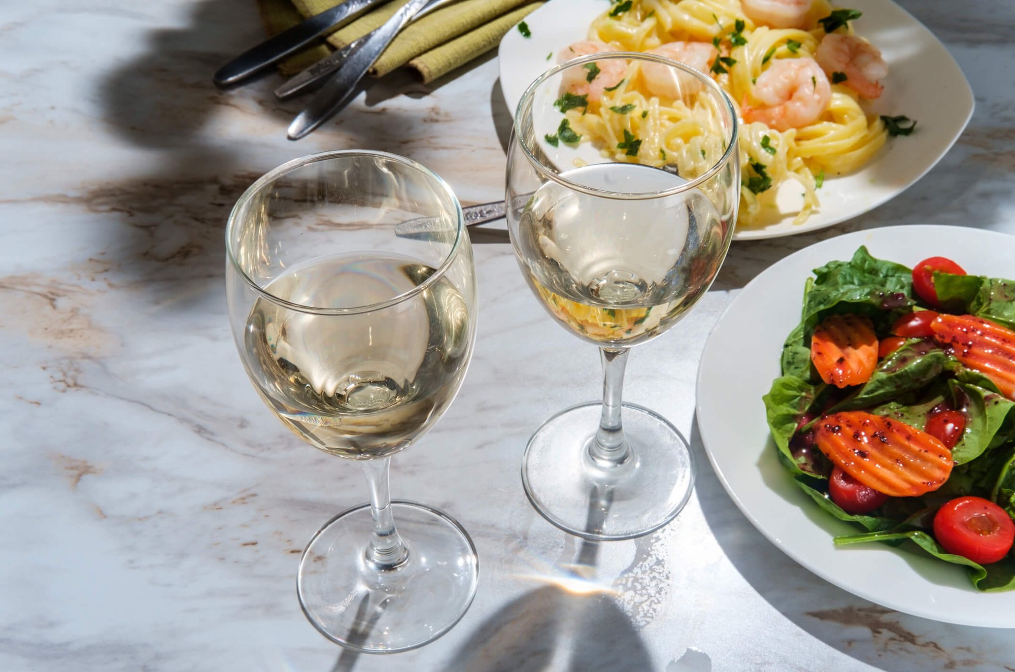 wine glasses and food on table