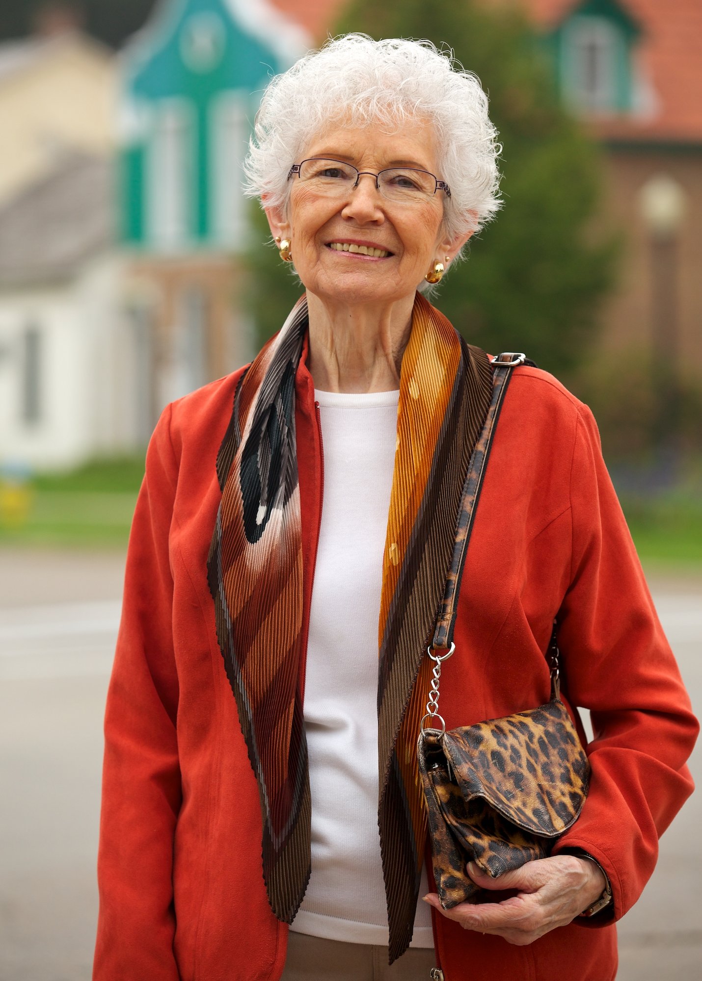 A senior woman smiling outside