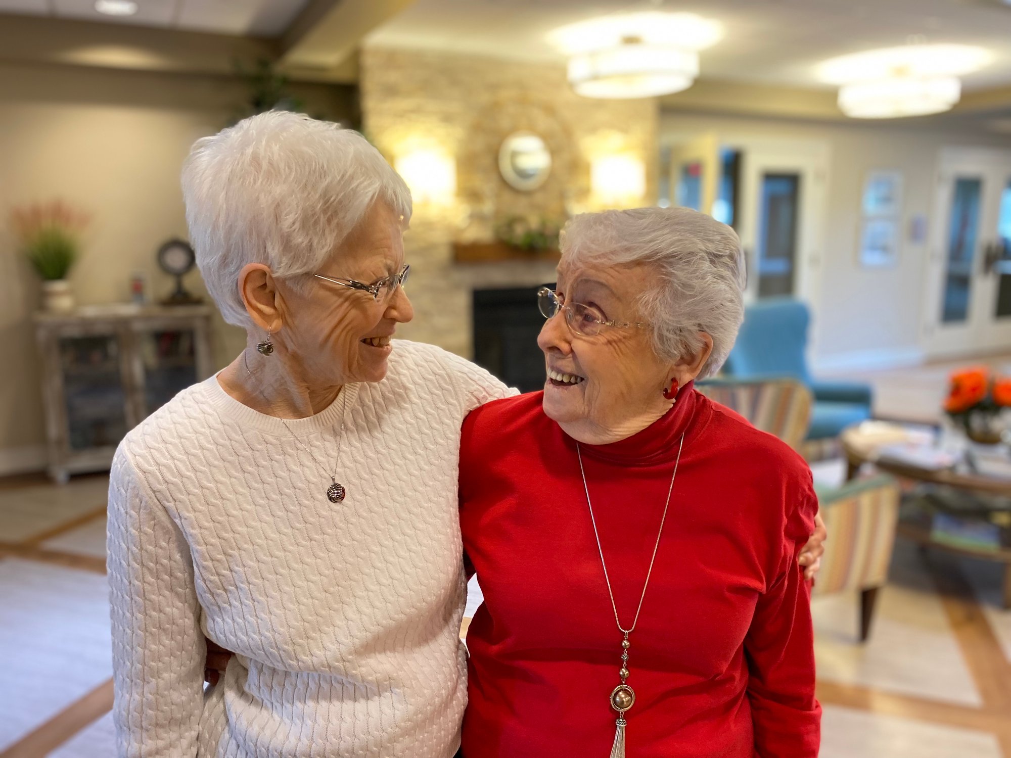 Two older women sharing an embrace 