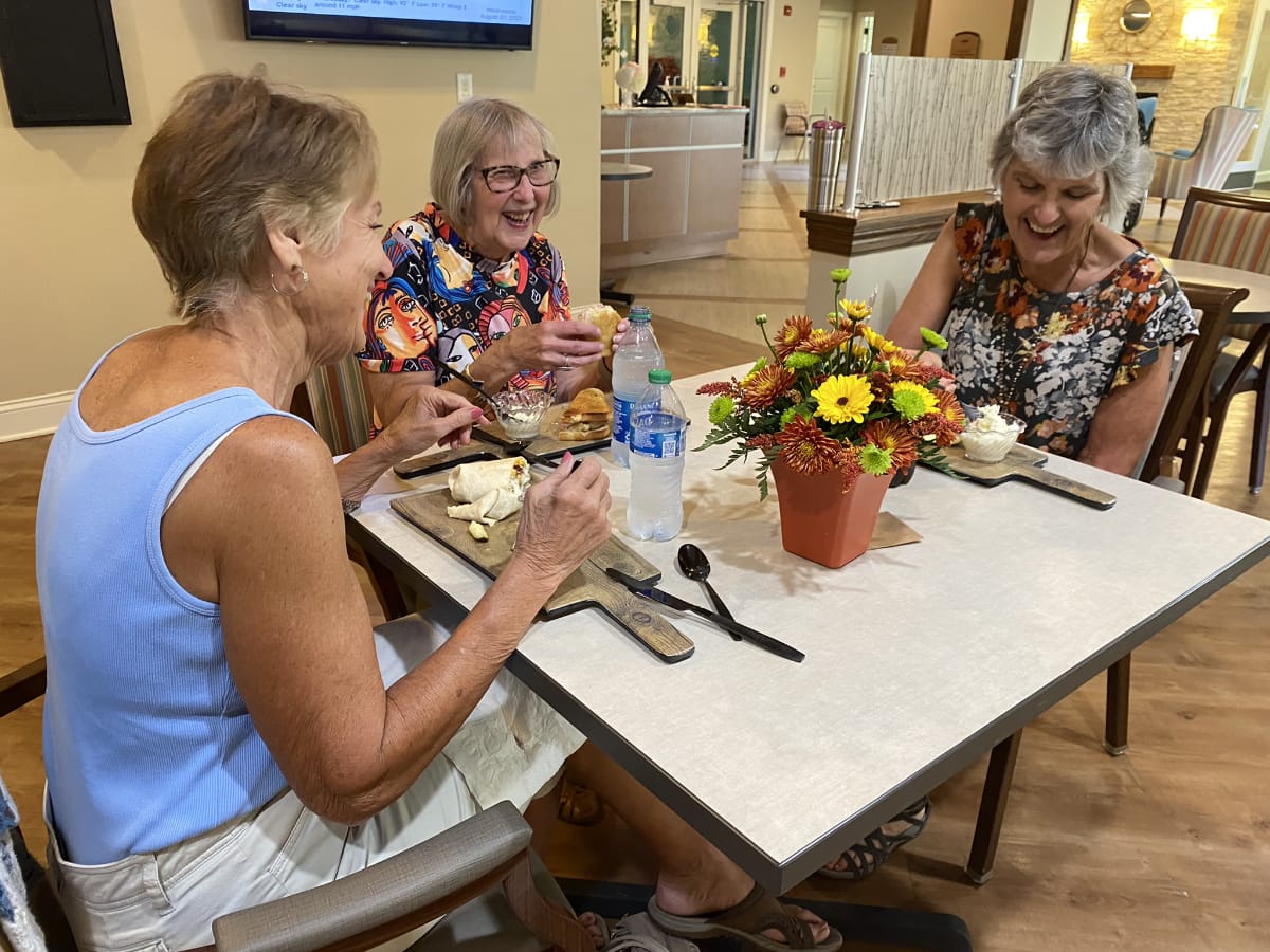 Friends around a table eating in dining room