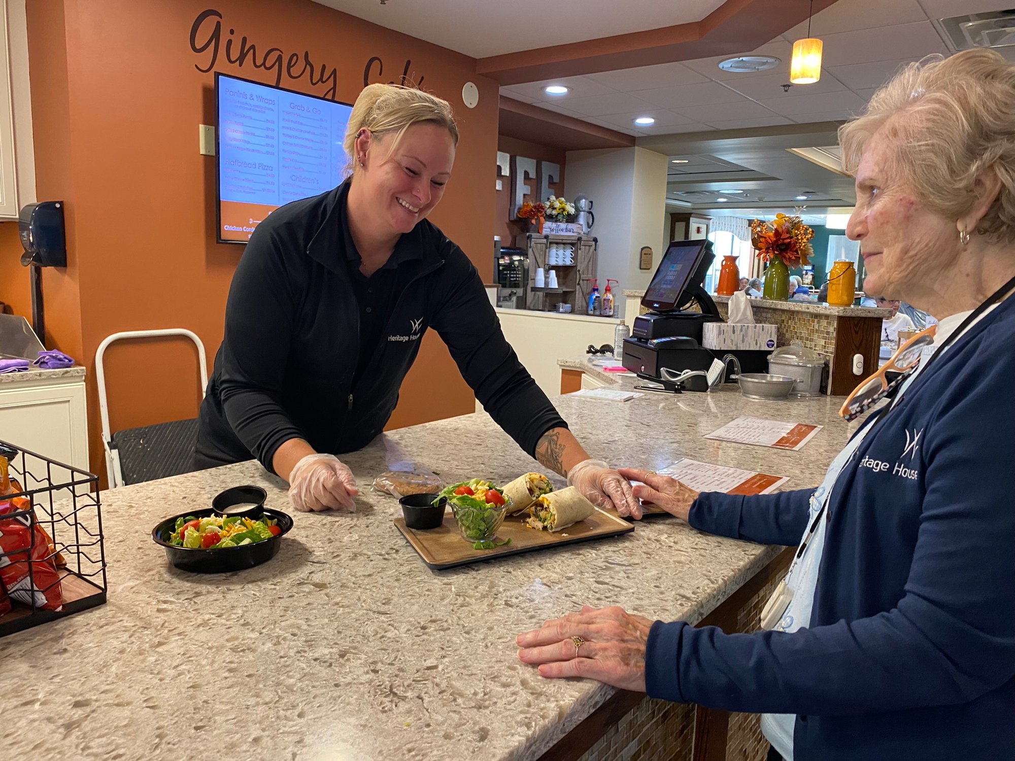 A waitress giving a resident food