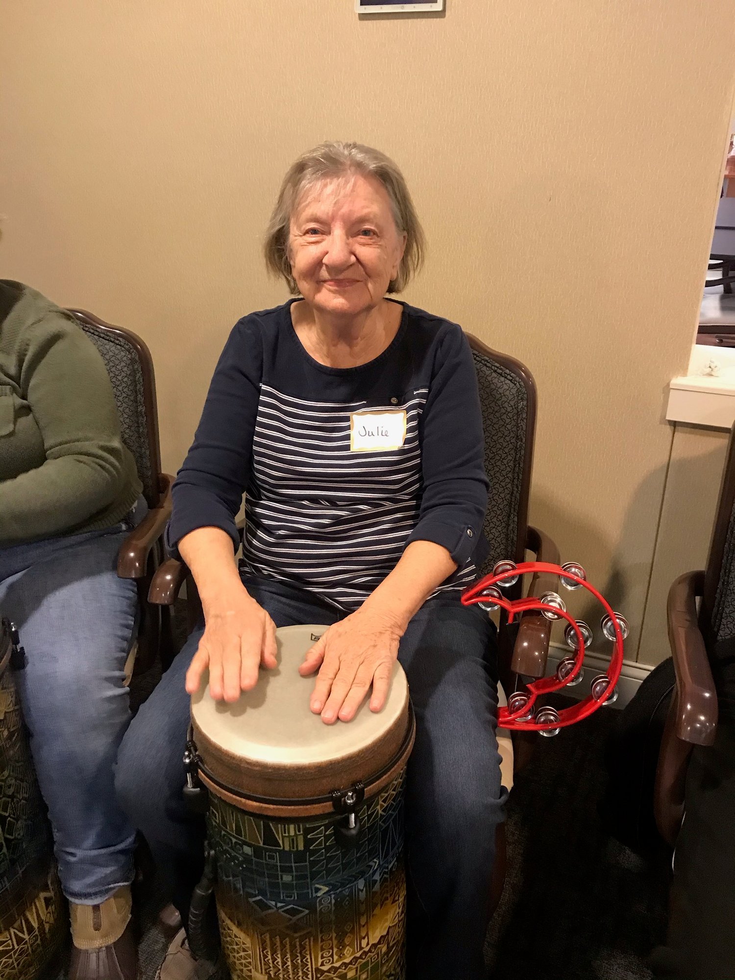 Senior woman playing the bongo and a tambourine