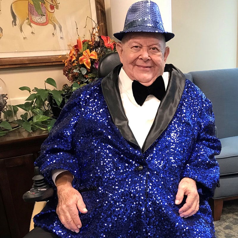 Jim Collier wearing a sparkly blue suit. 