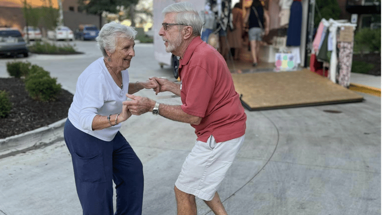 Two people dancing on a patio