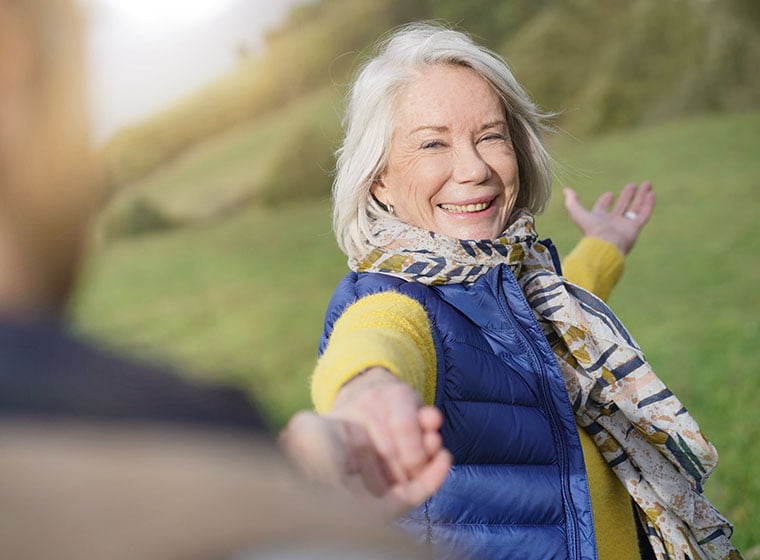 Senior woman smiling in a garden