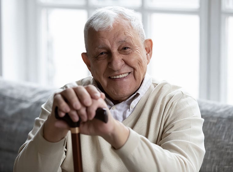 Senior man smiling from a living room