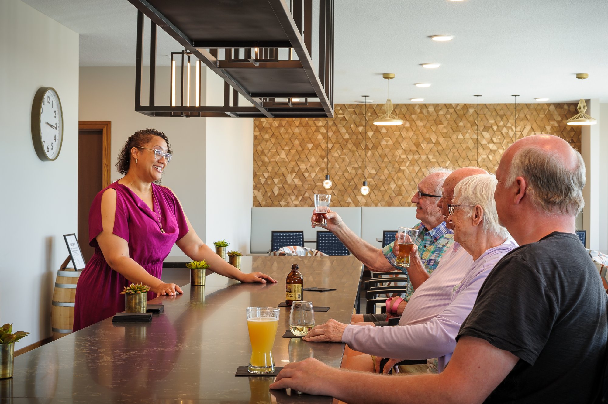 Senior friends having a drink at the bar