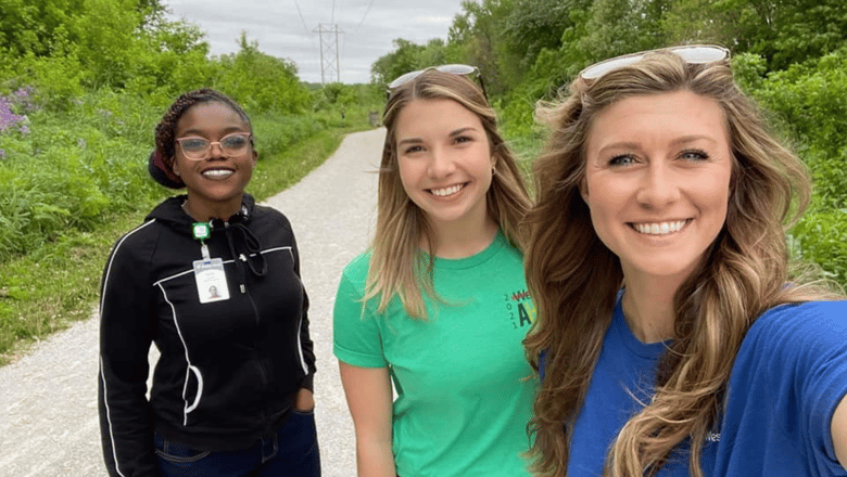 Three team members on a walk together