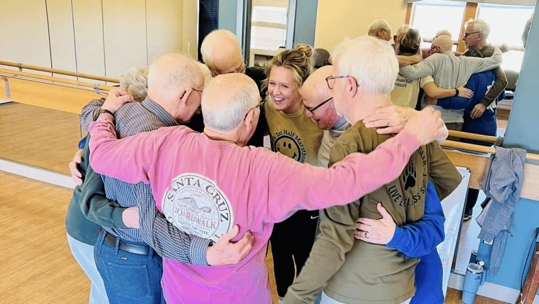 A team member hugging a group of senior residents