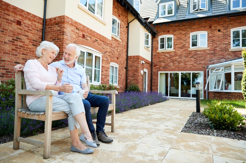 Senior Living couple enjoying time outside in a cottage community 