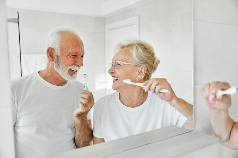 Senior Couple in the bathroom brushing their teeth