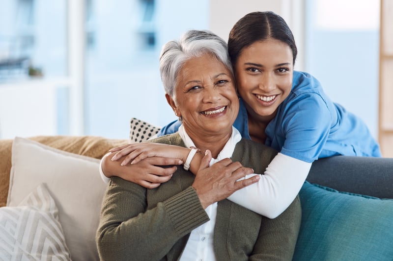 Senior living Patient with caretaker hugging