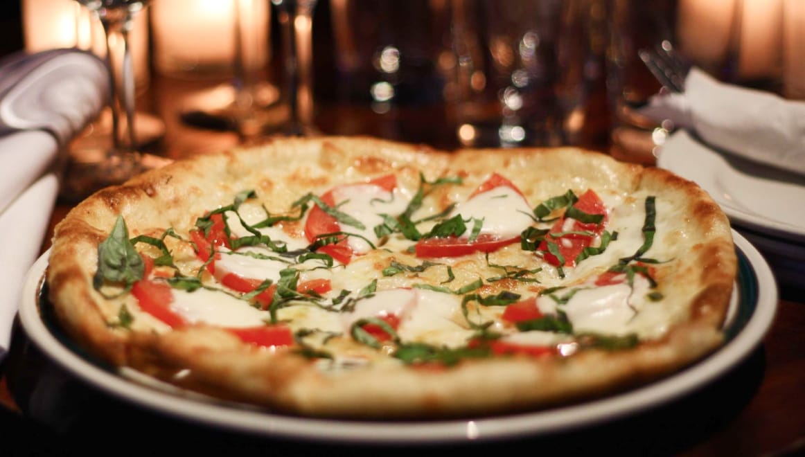 Margherita pizza on a plate.