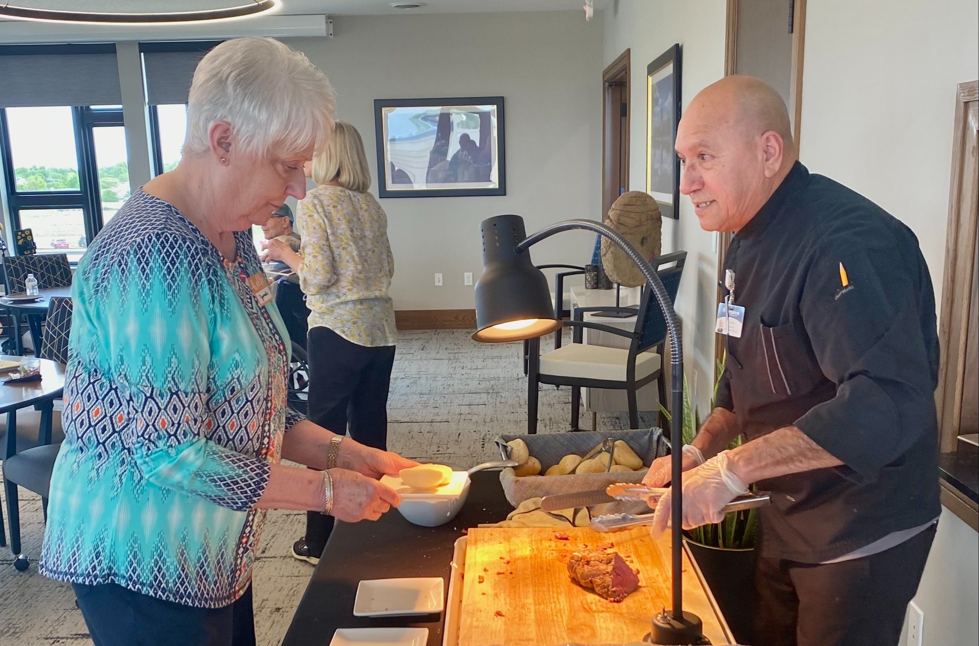 resident getting food from carving station