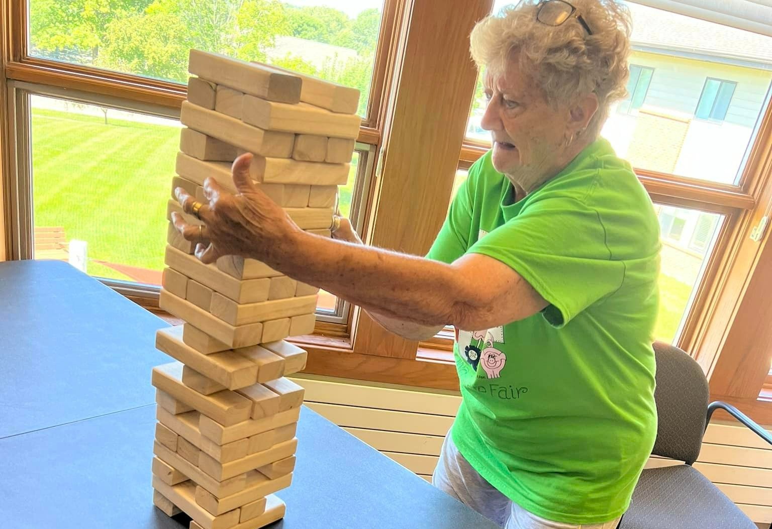 resident playing jenga inside