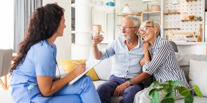 An older couple discussing their long-term and short-term care needs with a nurse.