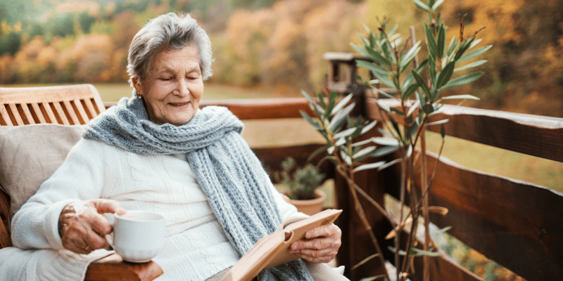 senior woman reading a book on aging