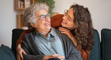 senior woman and daughter embracing