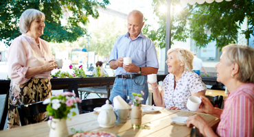 smiling senior friends having coffee
