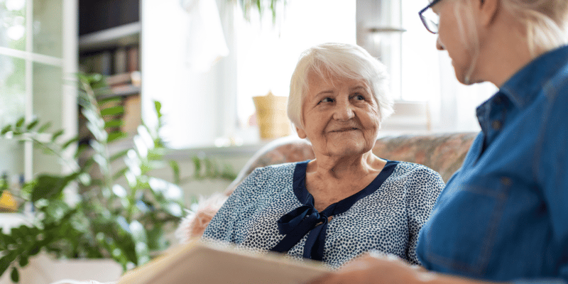 Senior woman smiling at caregiver