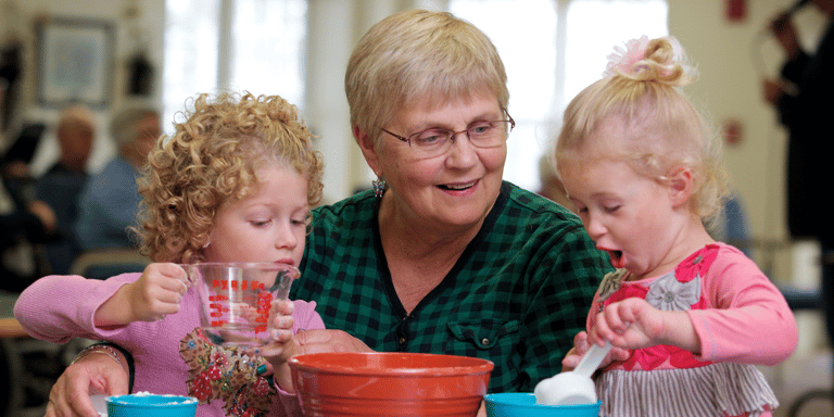 Senior woman smiling with her two grandchildren 