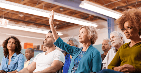 senior woman raising her hand